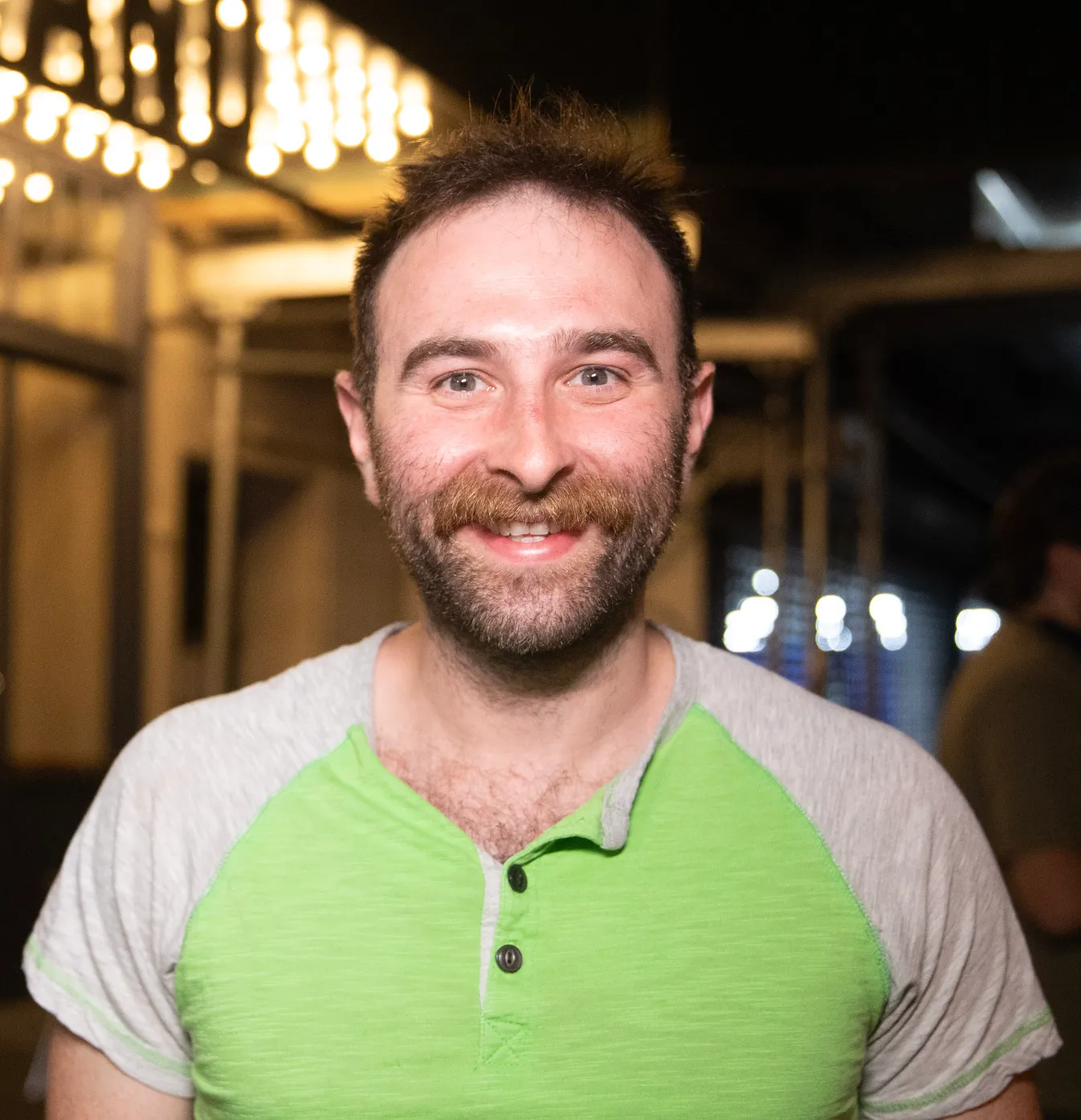 Boris Khaykin smiling outside under marquee lights